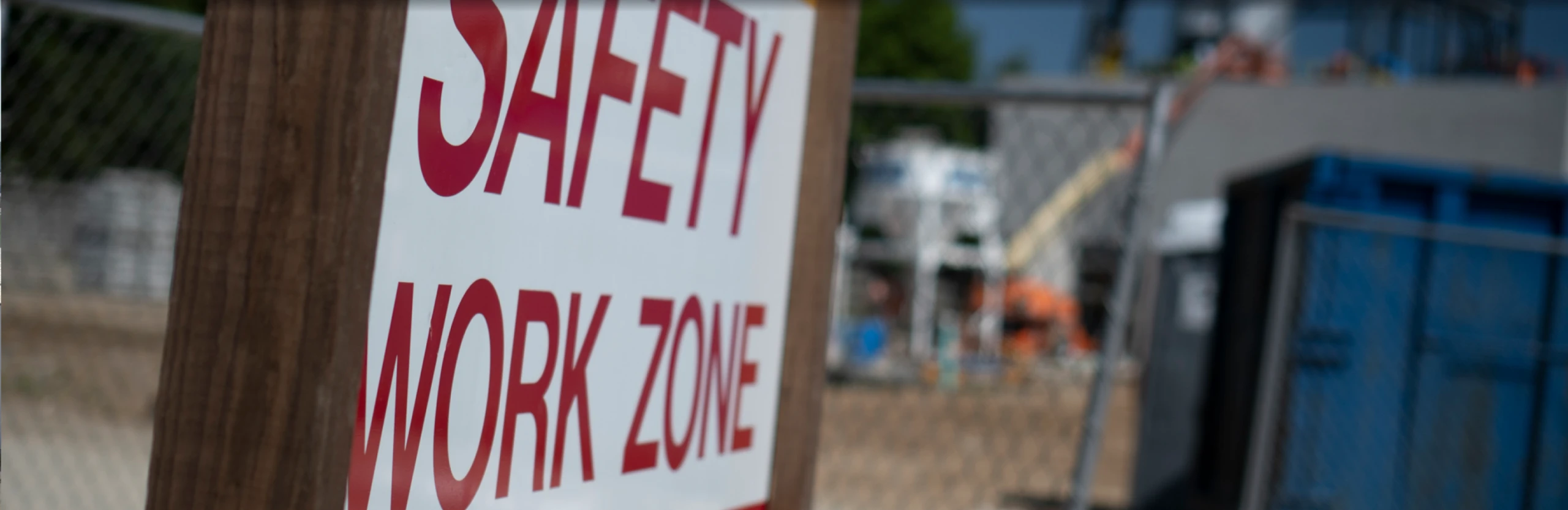 sign that says "safety work zone" in construction area